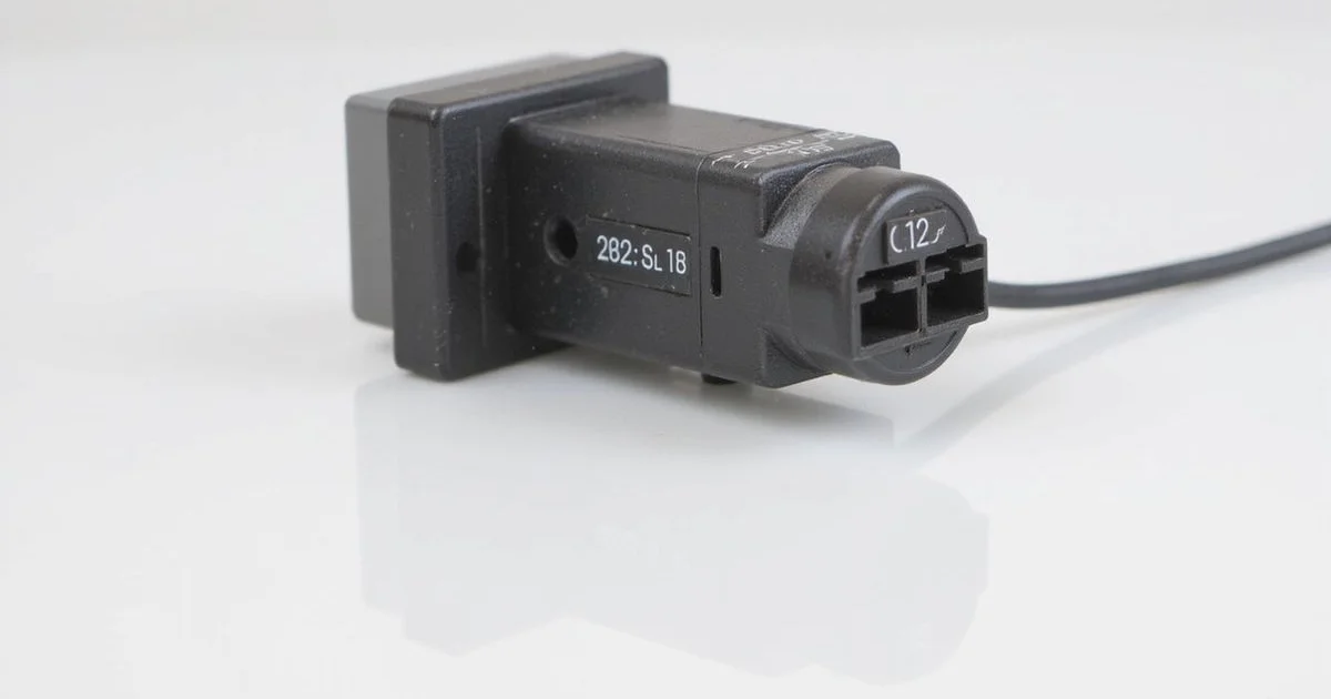 Close-up of aircon thermistor sensor component near evaporator coils